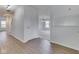 Hallway with hardwood floors and white walls, leading to carpeted living area with stairs on the left at 10343 Waveland Cir, Fishers, IN 46038