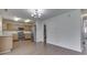 A view of the kitchen with stainless steel appliances, wood cabinets, and an adjacent doorway to the bathroom at 10343 Waveland Cir, Fishers, IN 46038