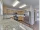 Kitchen with stainless steel appliances and wood cabinets, with an open doorway to another room at 10343 Waveland Cir, Fishers, IN 46038