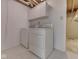 Well-lit laundry room featuring white washer and dryer, and upper cabinets at 10343 Waveland Cir, Fishers, IN 46038