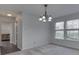 Bright living room featuring neutral carpet, white walls, and an elegant chandelier at 10343 Waveland Cir, Fishers, IN 46038