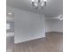 An empty, spacious living room with hardwood floors and a simple light fixture at 10343 Waveland Cir, Fishers, IN 46038
