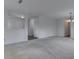 Spacious living room with neutral colored carpet and white walls, illuminated by overhead lighting at 10343 Waveland Cir, Fishers, IN 46038
