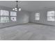 Bright and spacious living room with multiple windows providing ample natural light and neutral carpet at 10343 Waveland Cir, Fishers, IN 46038