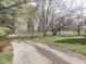 A scenic paved pathway winds through a lush park with mature trees, offering a tranquil escape at 10343 Waveland Cir, Fishers, IN 46038