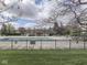 A fenced pool area with a serene swimming pool, lounge chairs, and a clubhouse, surrounded by lush trees at 10343 Waveland Cir, Fishers, IN 46038