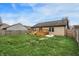 Large backyard with wooden deck, green lawn, and secure fencing at 1086 Meadowview Ct, Franklin, IN 46131