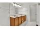 Bathroom featuring a double sink vanity, light fixtures, and white tile flooring at 1086 Meadowview Ct, Franklin, IN 46131