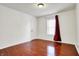 Bedroom with hardwood floors, a window, and a door at 1086 Meadowview Ct, Franklin, IN 46131