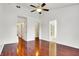 Spacious bedroom featuring hardwood floors, a ceiling fan, and an ensuite bathroom at 1086 Meadowview Ct, Franklin, IN 46131