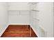 Walk-in closet with white shelving and hardwood flooring for optimal organization at 1086 Meadowview Ct, Franklin, IN 46131