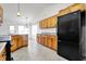 Kitchen featuring oak cabinetry, granite countertops, and modern black appliances at 1086 Meadowview Ct, Franklin, IN 46131