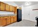 Bright kitchen with wooden cabinets, tile flooring, and modern black refrigerator at 1086 Meadowview Ct, Franklin, IN 46131