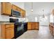 This kitchen is equipped with wooden cabinets, modern appliances, and neutral countertops for a functional cooking space at 1086 Meadowview Ct, Franklin, IN 46131