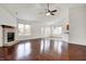 Open-concept living room with hardwood floors, a fireplace, and access to the kitchen and outdoor patio area at 1086 Meadowview Ct, Franklin, IN 46131