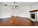 Spacious living room with hardwood floors, a brick fireplace, and neutral paint, offering a cozy and inviting atmosphere at 1086 Meadowview Ct, Franklin, IN 46131