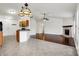 Open concept living room with a fireplace, wood floors, and a breakfast bar at 1086 Meadowview Ct, Franklin, IN 46131