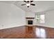 Living area with a fireplace and a large window, showcasing hardwood flooring at 1086 Meadowview Ct, Franklin, IN 46131