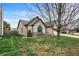 Side yard of home with green lawn, tidy landscaping, and patio area with seating, partially shaded by a mature tree at 1086 Meadowview Ct, Franklin, IN 46131