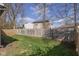 A large fenced-in backyard with mature trees, offering privacy and shade for outdoor activities at 10946 Snowdrop Way, Indianapolis, IN 46235