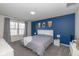 Bedroom with a large bed, accent wall, and plenty of natural light at 10946 Snowdrop Way, Indianapolis, IN 46235