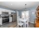 Eat-in kitchen with white dining table and stainless steel appliances at 10946 Snowdrop Way, Indianapolis, IN 46235