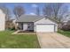 Charming single-story home featuring a two-car garage and a well-maintained front lawn at 10946 Snowdrop Way, Indianapolis, IN 46235