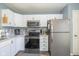 Modern kitchen featuring white cabinets, stainless steel appliances, and ample counter space at 10946 Snowdrop Way, Indianapolis, IN 46235