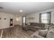 Bright living room with large windows, neutral paint, and a comfortable sectional sofa at 10946 Snowdrop Way, Indianapolis, IN 46235
