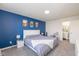 Bright main bedroom features en-suite bathroom, plush carpet, and a stylish accent wall at 10946 Snowdrop Way, Indianapolis, IN 46235