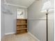 A carpeted basement area features a wooden shelf and hanging storage at 1135 E Southern Ave, Indianapolis, IN 46203