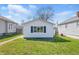 Charming home with white siding, a well-manicured lawn, and a quaint walkway to the front door at 1135 E Southern Ave, Indianapolis, IN 46203