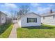 Charming home with white siding, a well-manicured lawn, and a quaint walkway to the front door at 1135 E Southern Ave, Indianapolis, IN 46203