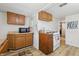 Functional kitchen with wooden cabinets, laminate floors and gas range at 1135 E Southern Ave, Indianapolis, IN 46203