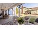 Relaxing covered patio with wicker seating, dining table, and view of the landscaped backyard at 12895 Grenville St, Carmel, IN 46032