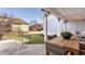 Inviting backyard patio featuring a wooden table with chairs, a ceiling fan, and pleasant outdoor view at 12895 Grenville St, Carmel, IN 46032