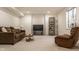 Cozy basement living room with neutral walls, a brown sofa, and a side table at 12895 Grenville St, Carmel, IN 46032