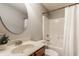Bathroom with a round mirror, white shower curtain, and a wood vanity with marble countertop at 12895 Grenville St, Carmel, IN 46032