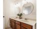 Bathroom featuring double sinks, framed mirrors, and dark wood cabinets at 12895 Grenville St, Carmel, IN 46032