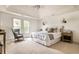 Bright bedroom with plush carpet, vaulted ceilings, and a cozy armchair at 12895 Grenville St, Carmel, IN 46032