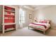 Cozy bedroom with natural light, a wooden bed frame, and built-in shelves at 12895 Grenville St, Carmel, IN 46032