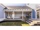 Spacious covered patio with elegant seating, a dining area, and well-manicured lawn at 12895 Grenville St, Carmel, IN 46032