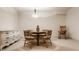 Neutral dining area featuring a table with seating for four, a rocking chair, and a dresser at 12895 Grenville St, Carmel, IN 46032