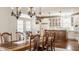 Open-concept dining room featuring hardwood floors, chandelier lighting and an adjoining kitchen space at 12895 Grenville St, Carmel, IN 46032