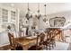 Elegant dining room with a wooden table, chandelier lighting, and a hutch for storing fine china at 12895 Grenville St, Carmel, IN 46032