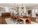 Large dining room with chandelier, wood table and chairs, that adjoins the kitchen at 12895 Grenville St, Carmel, IN 46032