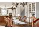 Chandelier-lit dining area with hardwood floors, dining table, and a view into the kitchen at 12895 Grenville St, Carmel, IN 46032