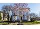 Charming blue two-story home with manicured lawn and an inviting front porch at 12895 Grenville St, Carmel, IN 46032