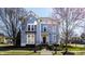 Charming blue two-story home with manicured lawn, brick walkway and an inviting front porch at 12895 Grenville St, Carmel, IN 46032