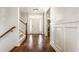 Bright foyer with hardwood floors, staircase and white wainscoting at 12895 Grenville St, Carmel, IN 46032